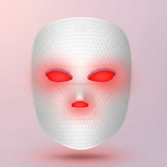 Glow Reset LED Light-Therapy Face Mask glowing red, on a soft pink-lilac background